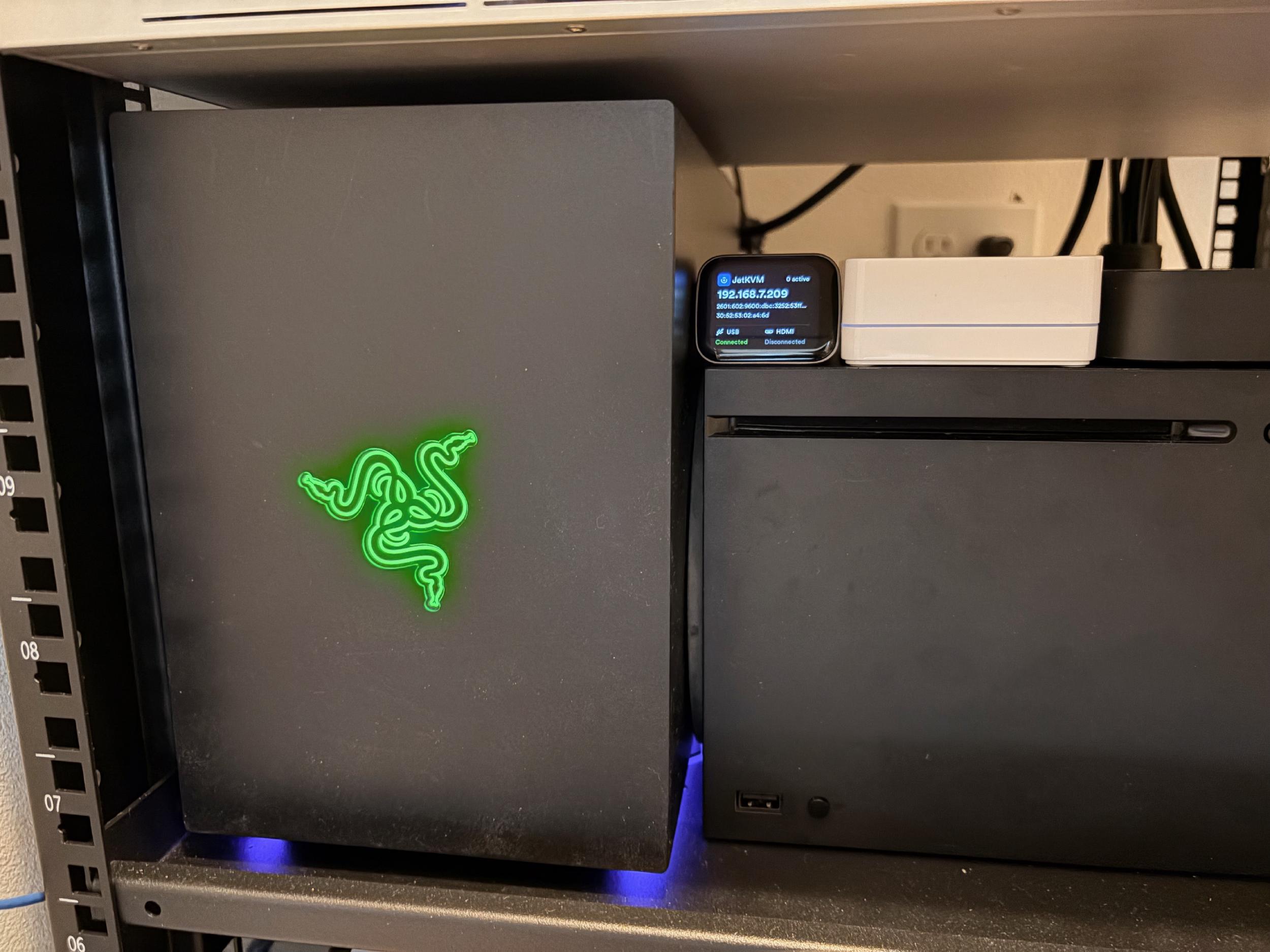 Photo of JetKVM connected to Tomahawk in the media closet (HDMI+USB)
